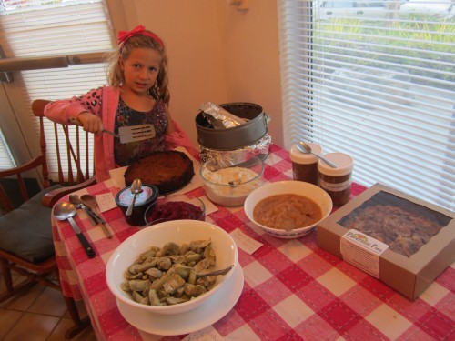 Miriam at vegan table cutting pumpkin pie